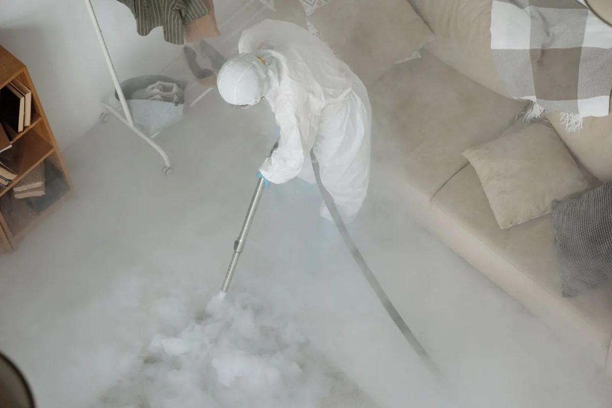 Biohazard cleanup technician in protective equipment, Hayes Valley, San Francisco, CA